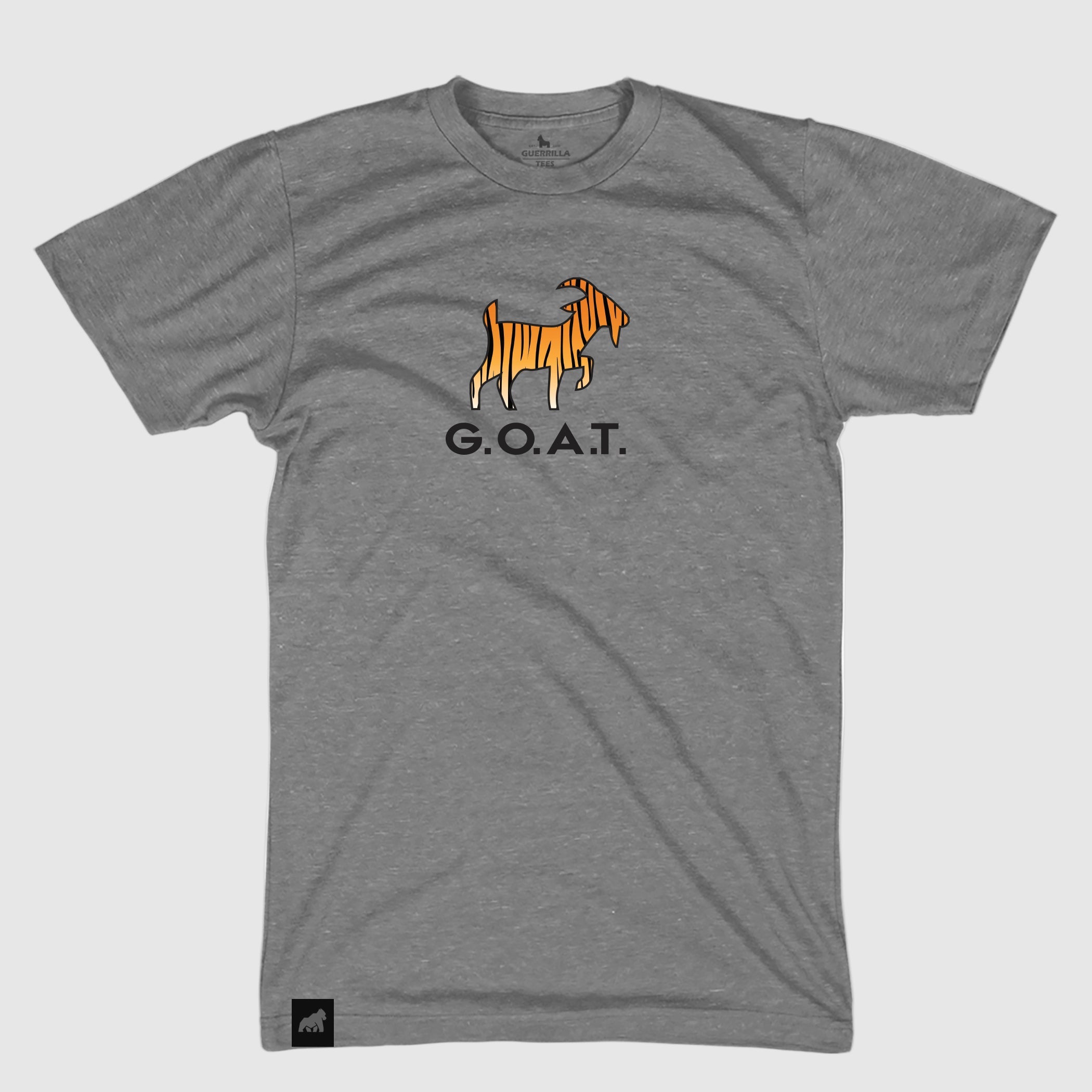 A gray crew neck t-shirt with a graphic of a tiger and the text 'G.O.A.T.' in orange and black on the front. for Tiger Woods the golfer.