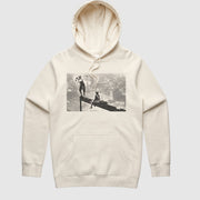 A beige hoodie with a screen printed front logo depicting a person standing on a high building, with the GRLA logo on the sleeve.